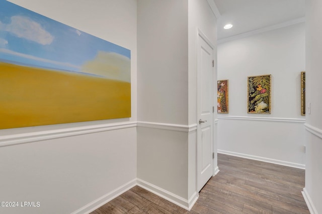 corridor featuring hardwood / wood-style flooring and crown molding