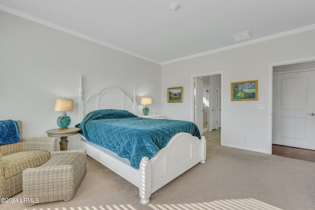 carpeted bedroom with ensuite bath and ornamental molding