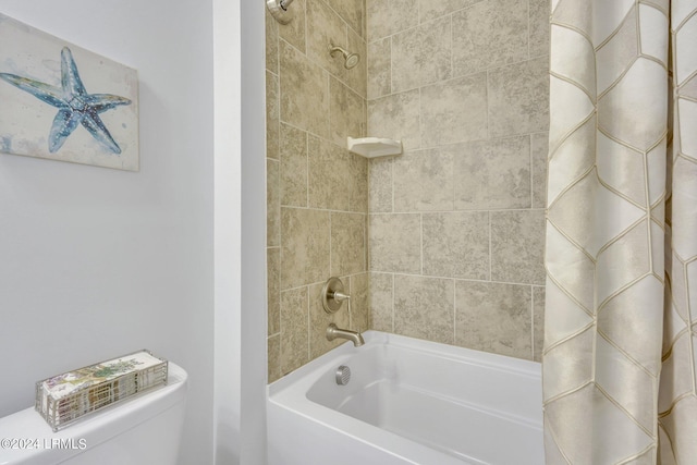 bathroom featuring shower / bath combination with curtain and toilet