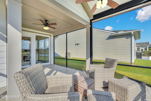 sunroom with ceiling fan and lofted ceiling