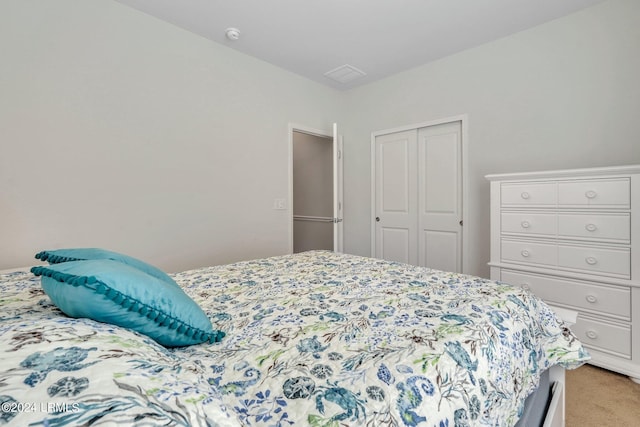 carpeted bedroom featuring a closet