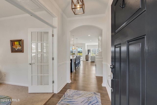 entryway featuring ornamental molding and dark hardwood / wood-style floors