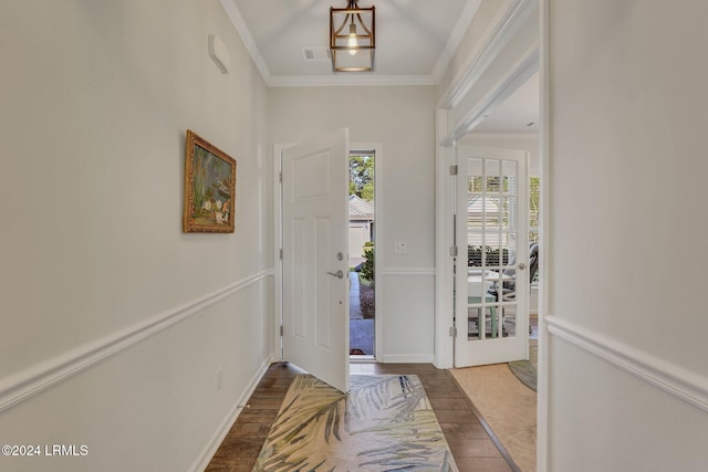 entrance foyer with dark wood-type flooring and ornamental molding