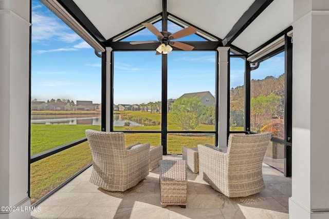 sunroom / solarium featuring a water view, ceiling fan, plenty of natural light, and lofted ceiling