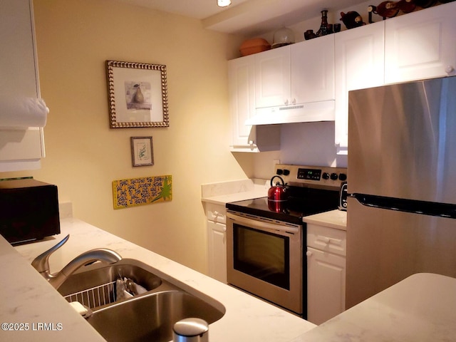 70 Helmsman Way Unit 1410, Hilton Head Island, SC 29928 - kitchen featuring appliances with stainless steel finishes, under cabinet range hood, and white cabinetry