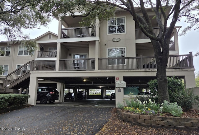 70 Helmsman Way Unit 1410, Hilton Head Island, SC 29928 - view of building exterior with driveway and a carport