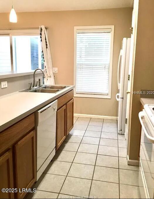 14 Arbormeade Cir, Bluffton, SC 29910 - kitchen with white appliances, light tile patterned flooring, brown cabinetry, and light countertops