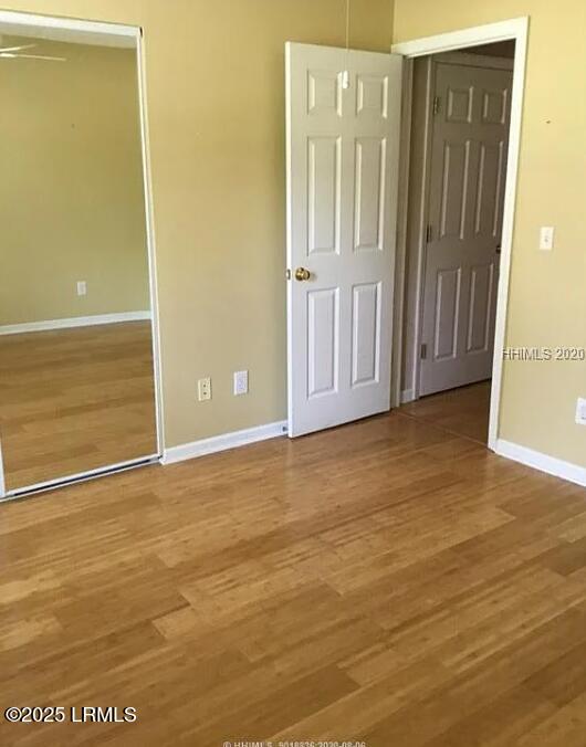 14 Arbormeade Cir, Bluffton, SC 29910 - unfurnished bedroom featuring wood finished floors and a closet