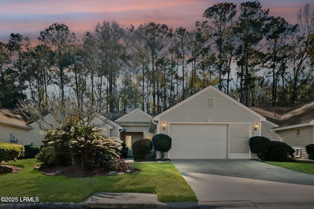 single story home featuring a front yard, an attached garage, and driveway