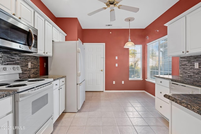 kitchen with tasteful backsplash, light tile patterned flooring, white cabinets, and white appliances