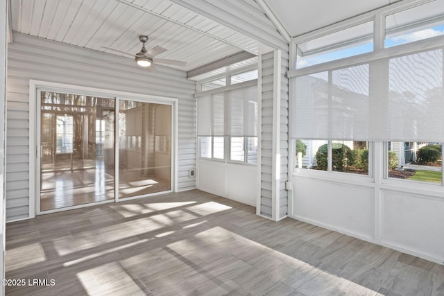 unfurnished sunroom with ceiling fan