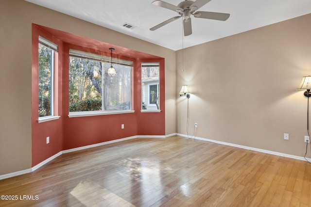 empty room featuring ceiling fan and light wood-type flooring