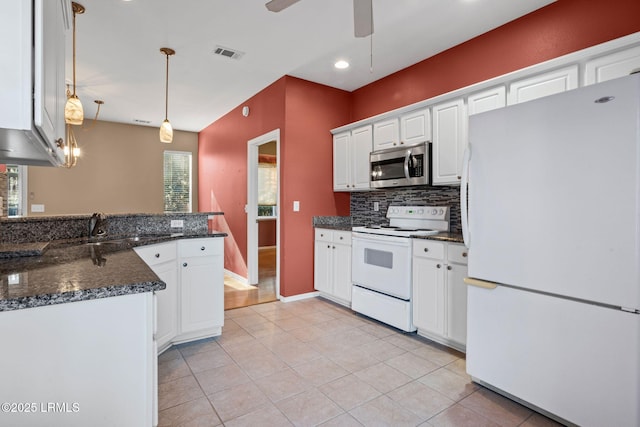 kitchen with pendant lighting, light tile patterned floors, white appliances, tasteful backsplash, and white cabinets