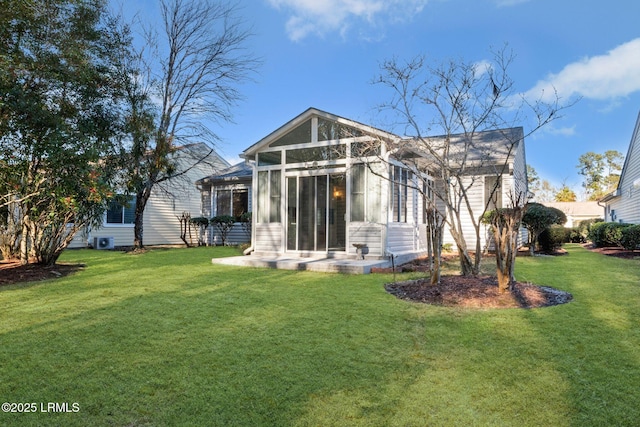 rear view of property with a yard