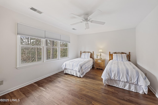 bedroom with dark wood-type flooring and ceiling fan