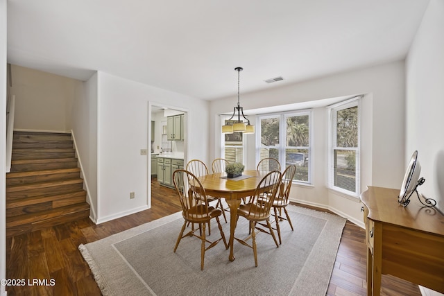 dining space featuring dark hardwood / wood-style flooring