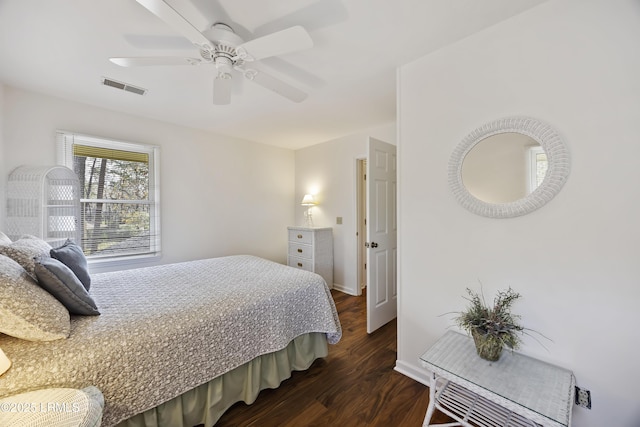 bedroom with dark hardwood / wood-style floors and ceiling fan