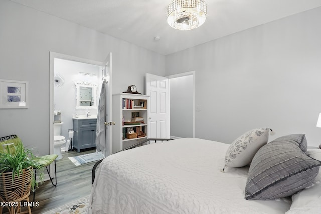 100 Kensington Blvd Unit 1503, Bluffton, SC 29910 - bedroom featuring wood finished floors, ensuite bath, a chandelier, and a sink