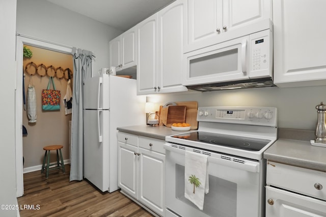 100 Kensington Blvd Unit 1503, Bluffton, SC 29910 - kitchen with white appliances, wood finished floors, white cabinets, and light countertops