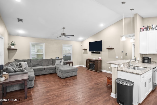 living room with vaulted ceiling, sink, dark wood-type flooring, and ceiling fan