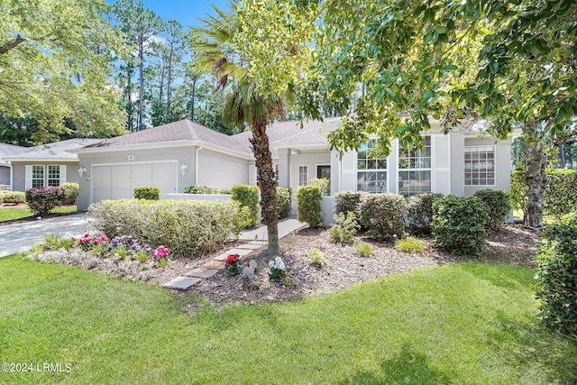 view of front of home featuring a garage and a front yard