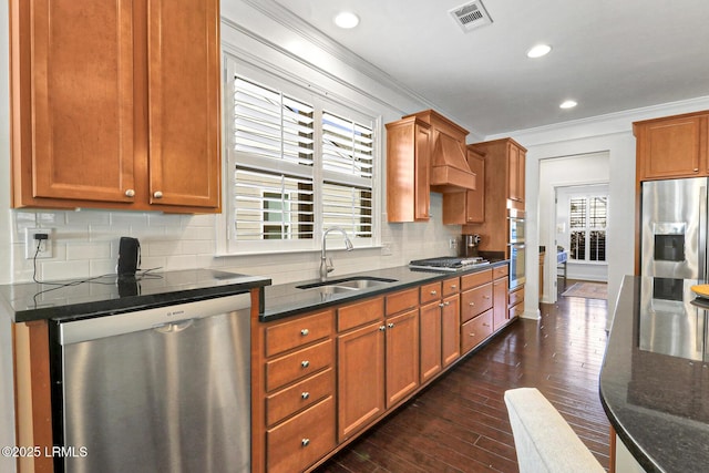 kitchen featuring dark hardwood / wood-style floors, tasteful backsplash, sink, ornamental molding, and stainless steel appliances