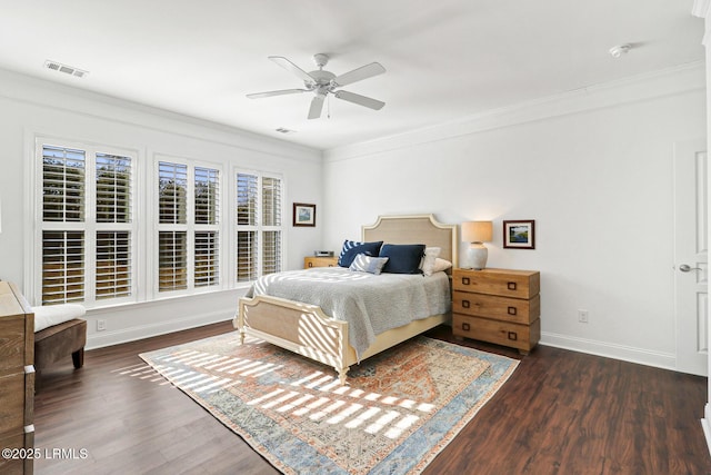 bedroom with dark wood-type flooring, ornamental molding, and ceiling fan