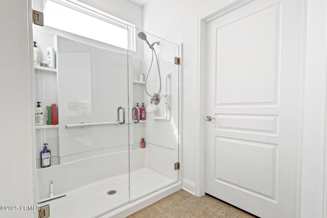 bathroom featuring tile patterned floors and an enclosed shower