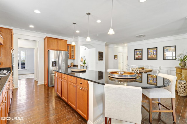 kitchen with a kitchen island, dark hardwood / wood-style floors, pendant lighting, and stainless steel fridge with ice dispenser