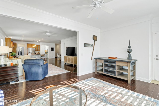 living room featuring ceiling fan, ornamental molding, and dark hardwood / wood-style flooring