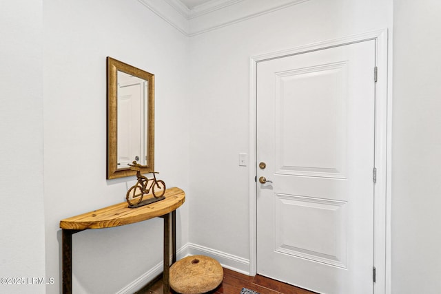 entryway featuring crown molding and dark hardwood / wood-style floors