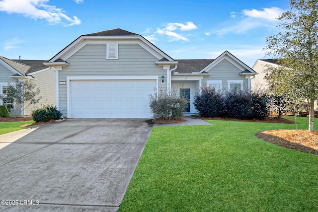 view of front of property featuring a garage and a front yard