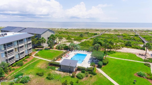 aerial view of a pool and a nearby body of water