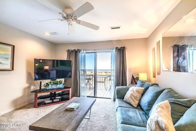 living room featuring carpet, ceiling fan, and baseboards