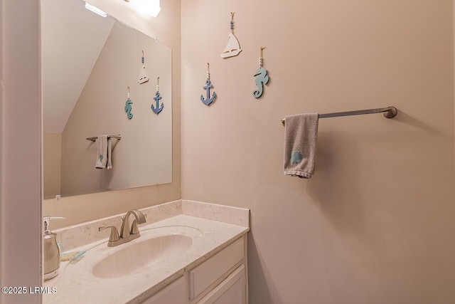 bathroom with vanity and vaulted ceiling