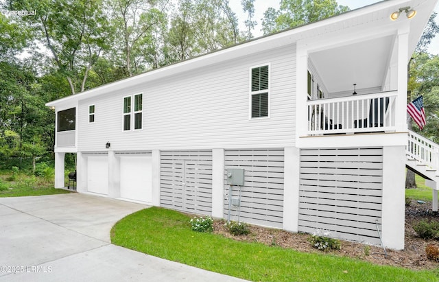 view of property exterior with a garage, driveway, and stairs