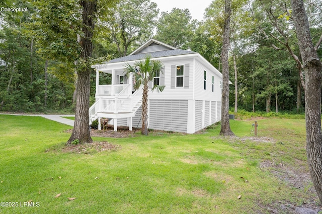 view of outdoor structure with covered porch and stairway