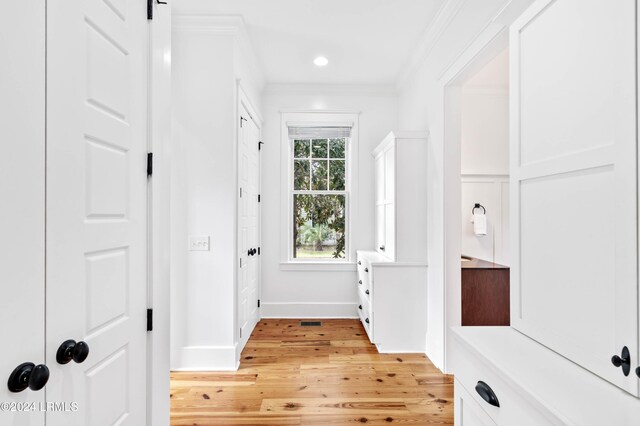 interior space featuring crown molding and light hardwood / wood-style floors