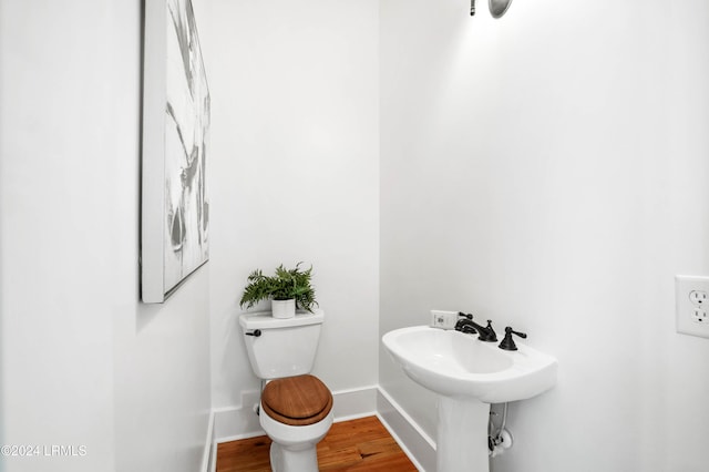 bathroom featuring sink, hardwood / wood-style flooring, and toilet