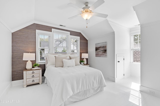 bedroom with crown molding, ceiling fan, vaulted ceiling, and wood walls