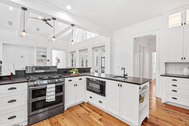 kitchen featuring pendant lighting, vaulted ceiling with beams, white cabinets, and range with two ovens