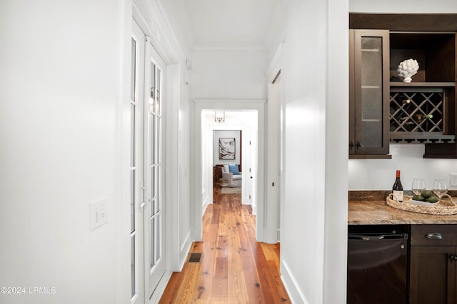 corridor featuring crown molding and light wood-type flooring