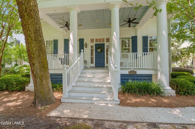 entrance to property featuring a porch and ceiling fan