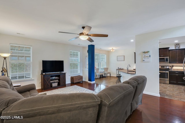 living area featuring ceiling fan, recessed lighting, wood finished floors, visible vents, and baseboards