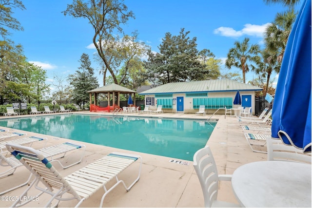 pool featuring a gazebo, a patio area, and fence