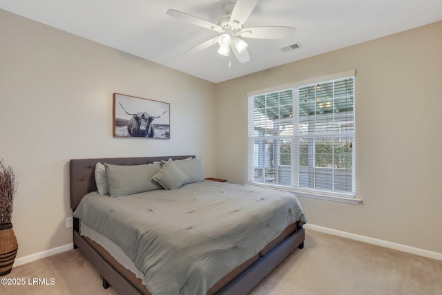 bedroom featuring light colored carpet, ceiling fan, visible vents, and baseboards