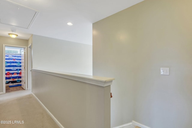 hall featuring attic access, recessed lighting, carpet floors, and baseboards