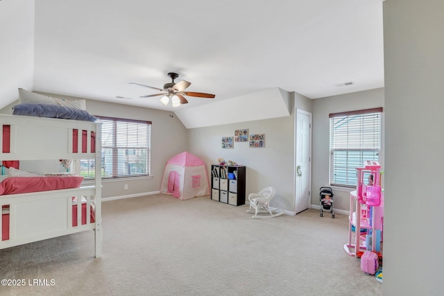 carpeted bedroom featuring lofted ceiling, visible vents, and baseboards