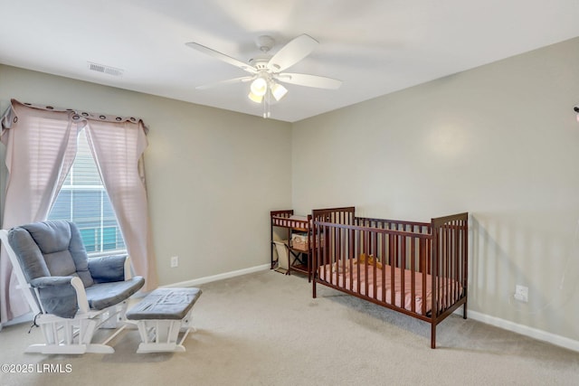 bedroom with a ceiling fan, light colored carpet, visible vents, and baseboards