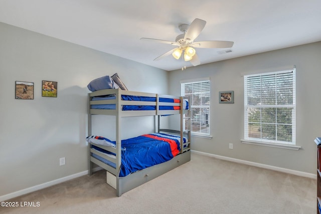 bedroom featuring light carpet, multiple windows, visible vents, and baseboards